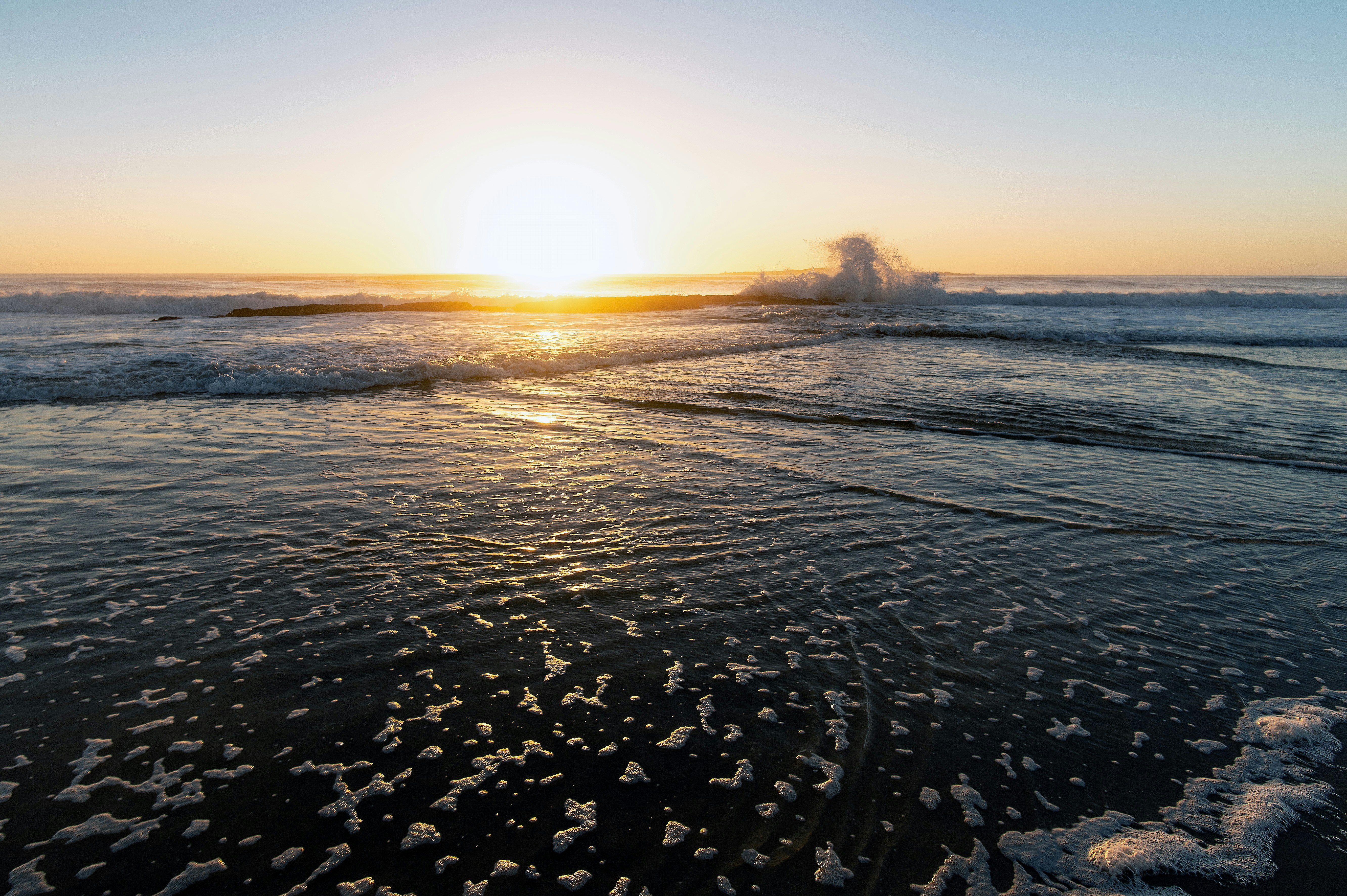 body of water during sunset